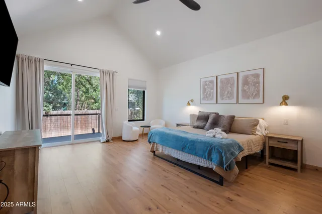 a bedroom with a bed and a large window
