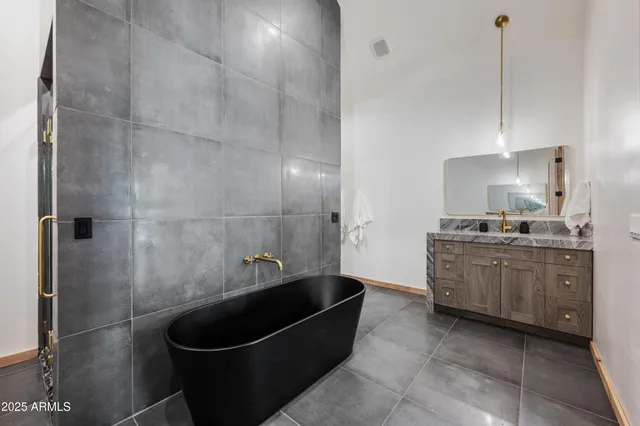 a bathroom with a granite countertop sink a toilet and bathtub