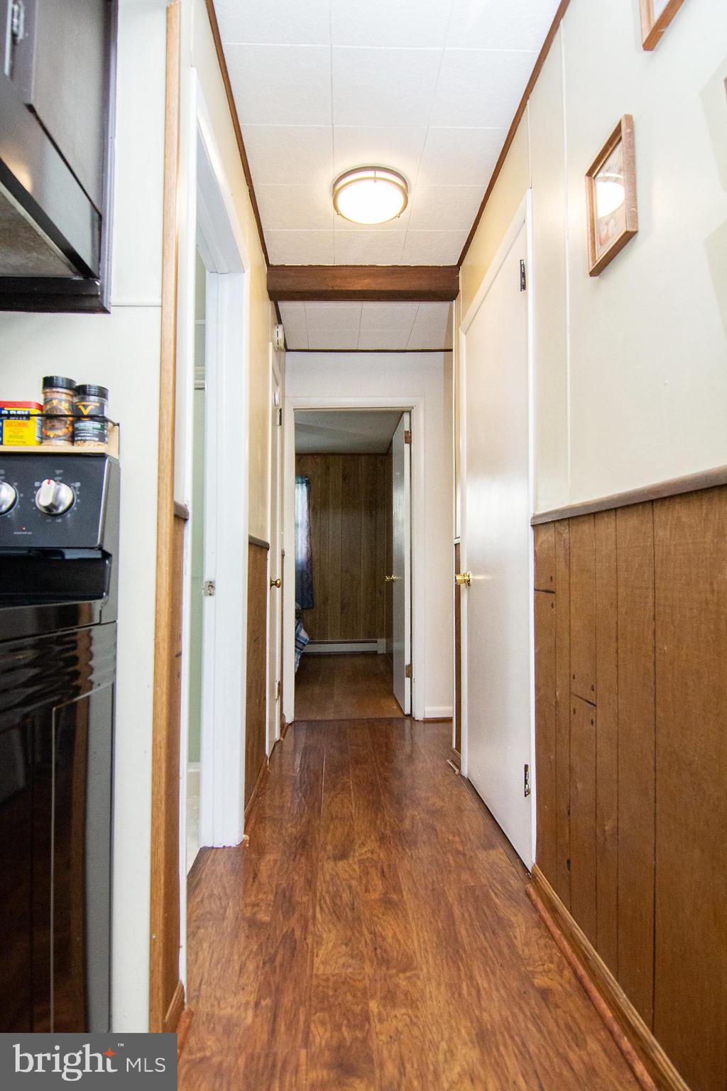 3548 Lineboro Road Manchester, MD 21102 - Photo 9 of 43 a view of a hallway with wooden floor and staircase