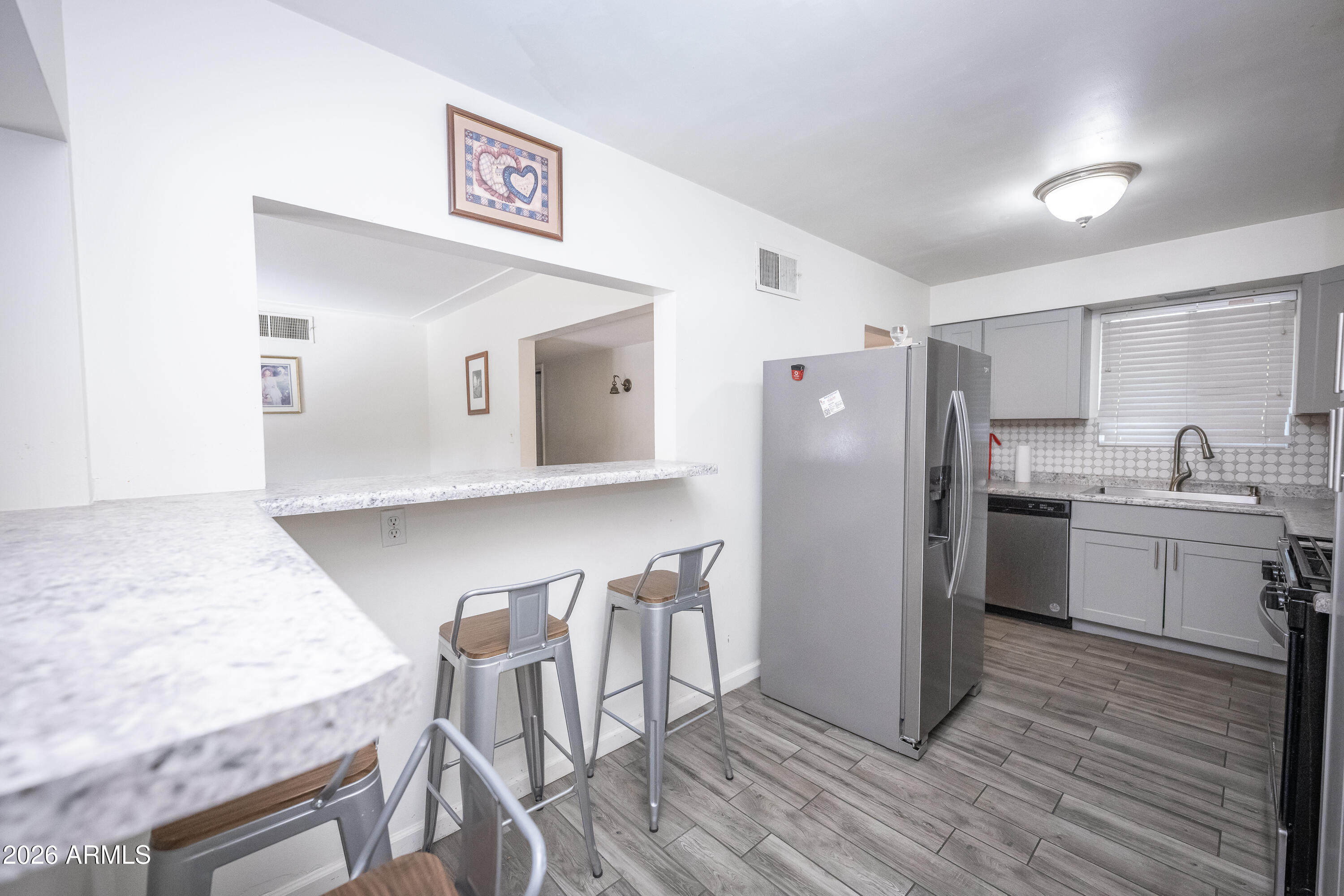 2101 West Glenn Drive Phoenix, AZ 85021 - Photo 21 of 48 a kitchen with granite countertop a refrigerator stove top oven and sink