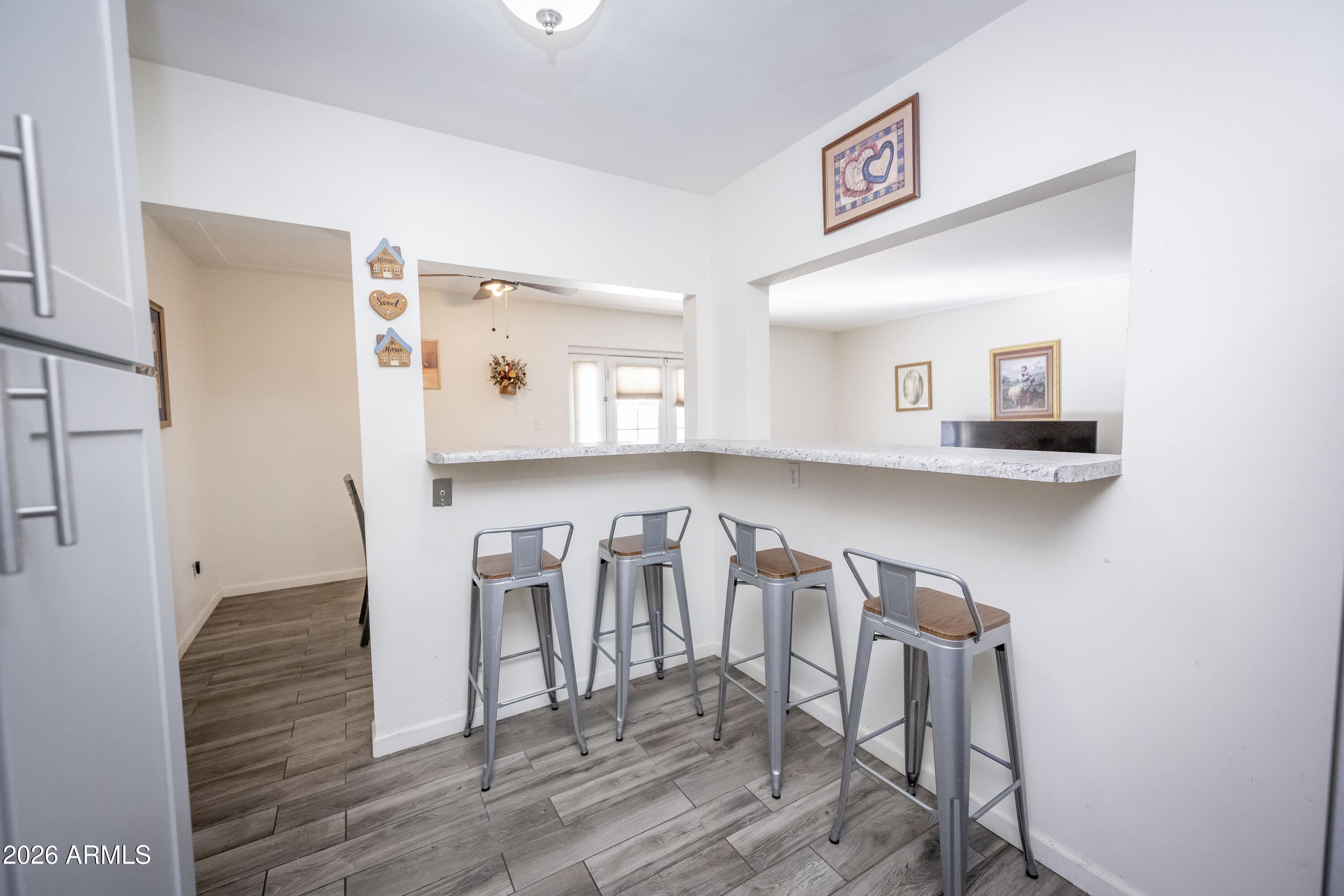 2101 West Glenn Drive Phoenix, AZ 85021 - Photo 22 of 48 a view of a dining room with furniture and wooden floor