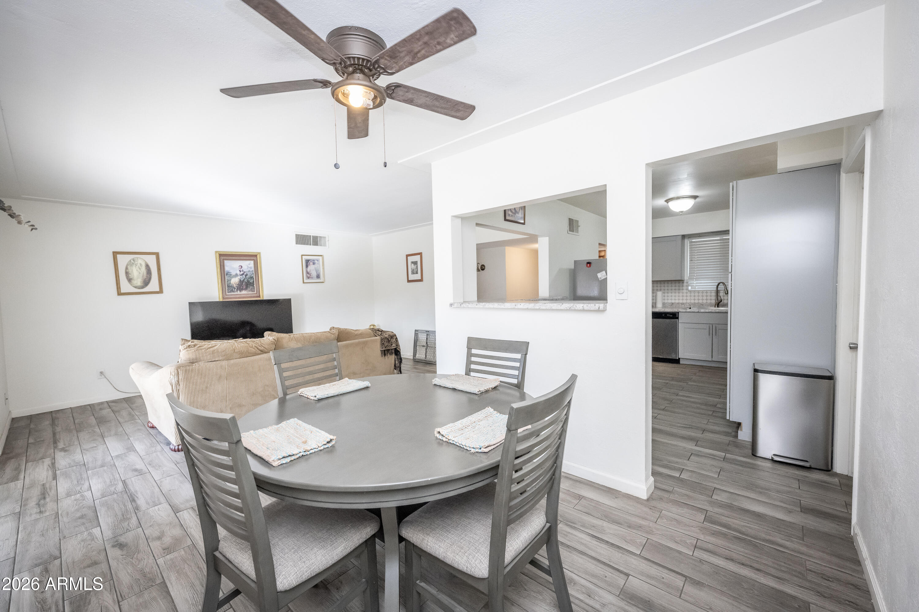2101 West Glenn Drive Phoenix, AZ 85021 - Photo 23 of 48 a view of a dining room with furniture and wooden floor