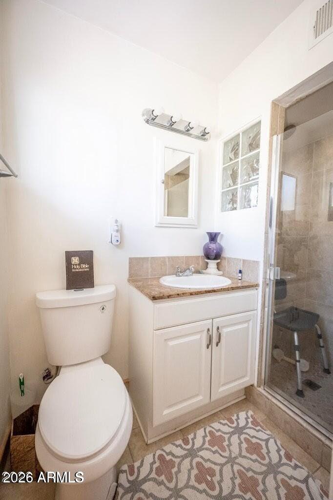 2101 West Glenn Drive Phoenix, AZ 85021 - Photo 41 of 48 a bathroom with a granite countertop toilet a sink and a mirror