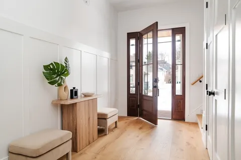 a view of a bedroom with a bed and a potted plant