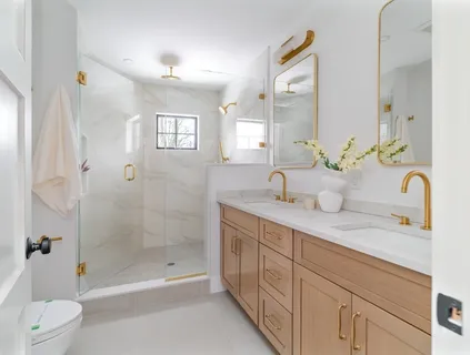 a spacious bathroom with a double vanity sink toilet and shower