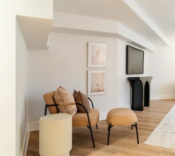 a bed sitting in a spacious bedroom next to a window