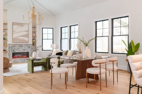 a view of a dining room with furniture a chandelier and wooden floor