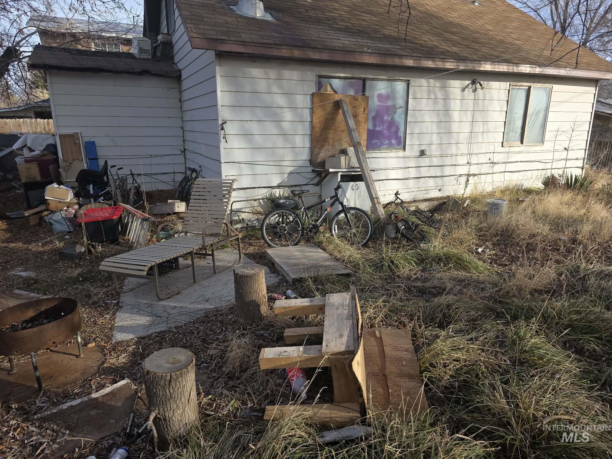 106 Walnut Street Rupert, ID 83350 - Photo 2 of 4 Back of property with a patio and roof with shingles