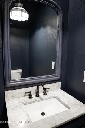 a bathroom with a sink and mirror