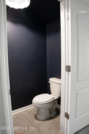 a white toilet sitting next to a shower