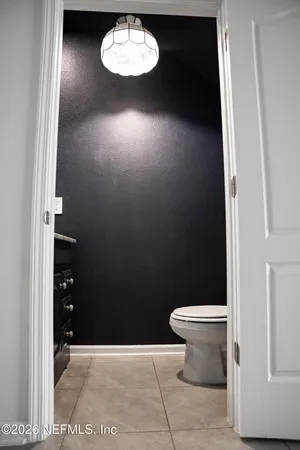 a bathroom with a toilet and a vanity