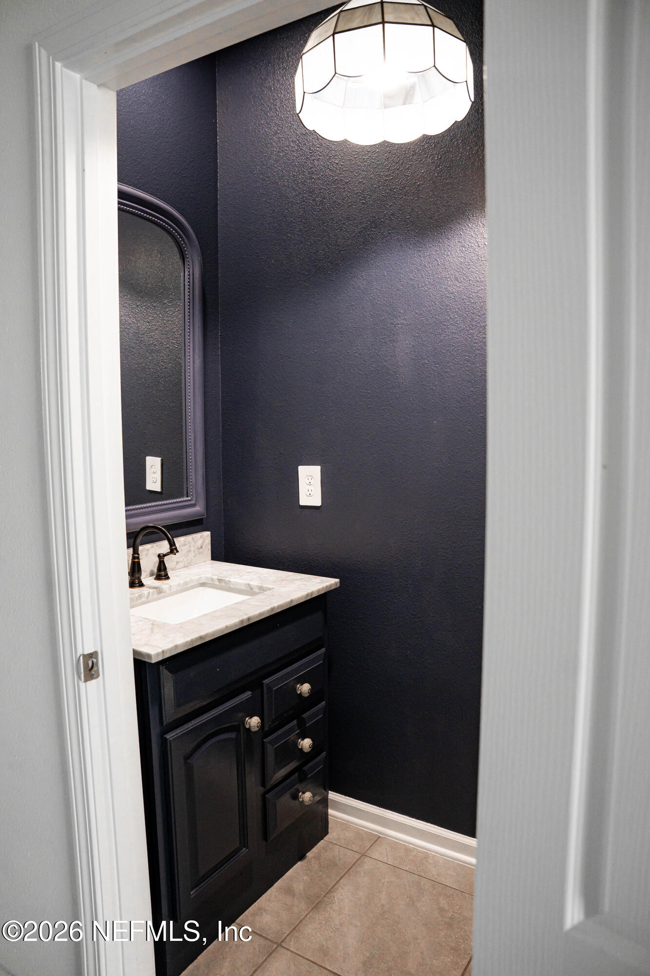 46 Wading Ibis Road St. Augustine, FL 32095 - Photo 17 of 31 a bathroom with a sink and a mirror