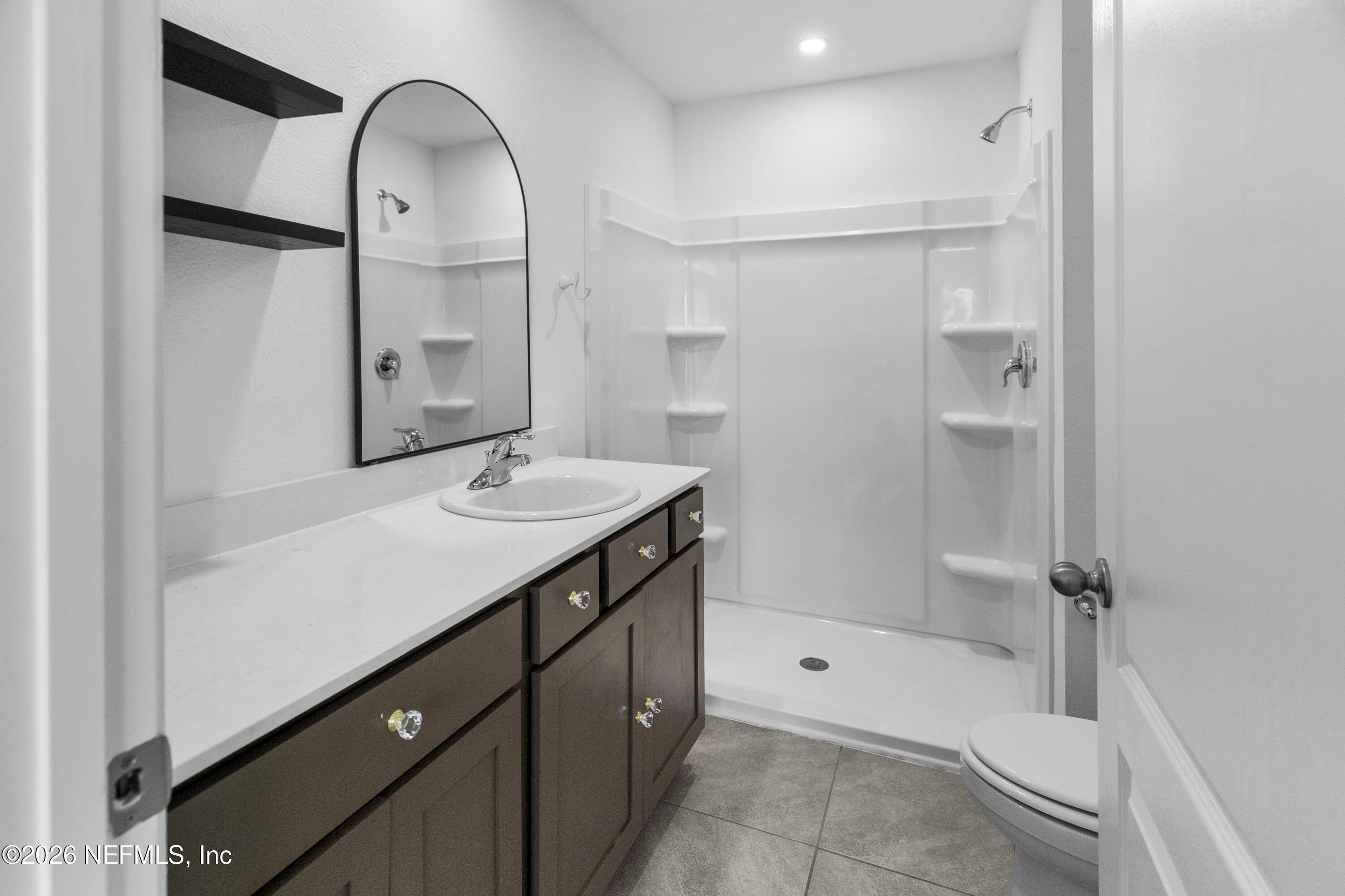 46 Wading Ibis Road St. Augustine, FL 32095 - Photo 20 of 31 a bathroom with a sink a toilet and shower
