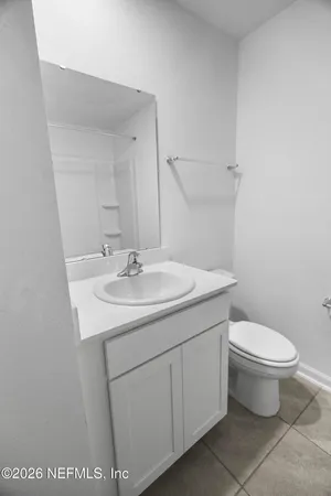 a bathroom with a sink toilet and a mirror