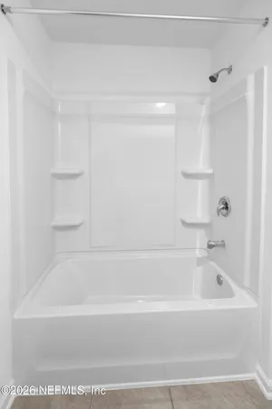 a bathroom with a bathtub and a shower