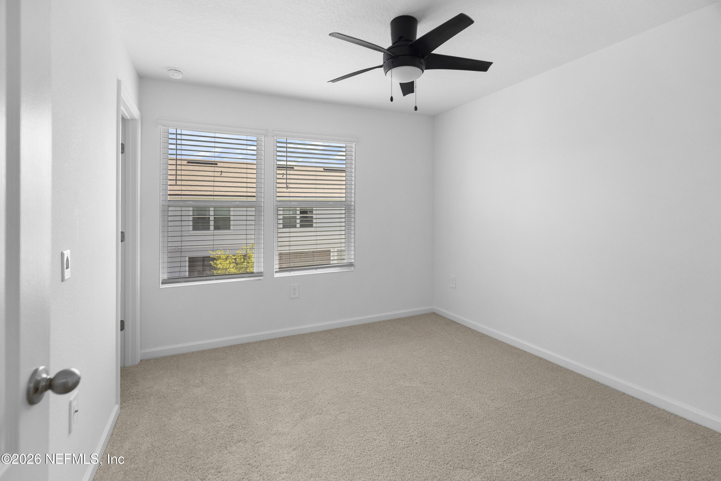 46 Wading Ibis Road St. Augustine, FL 32095 - Photo 29 of 31 an empty room with chandelier fan and windows