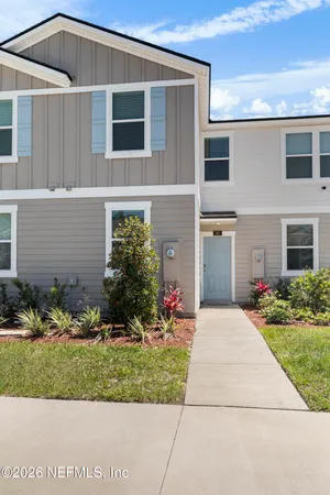 a front view of a house with a yard and outdoor seating
