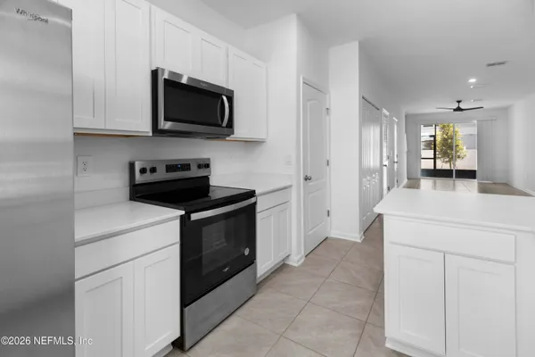 a kitchen with stainless steel appliances a stove microwave and cabinets