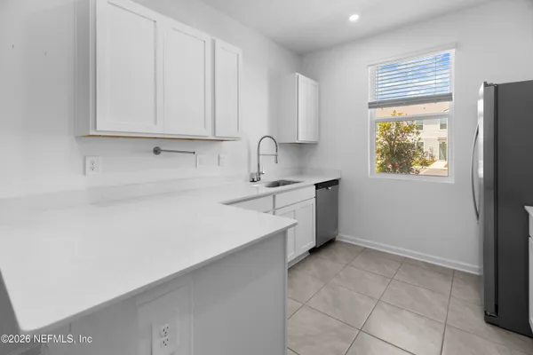 a kitchen with a sink cabinets and window