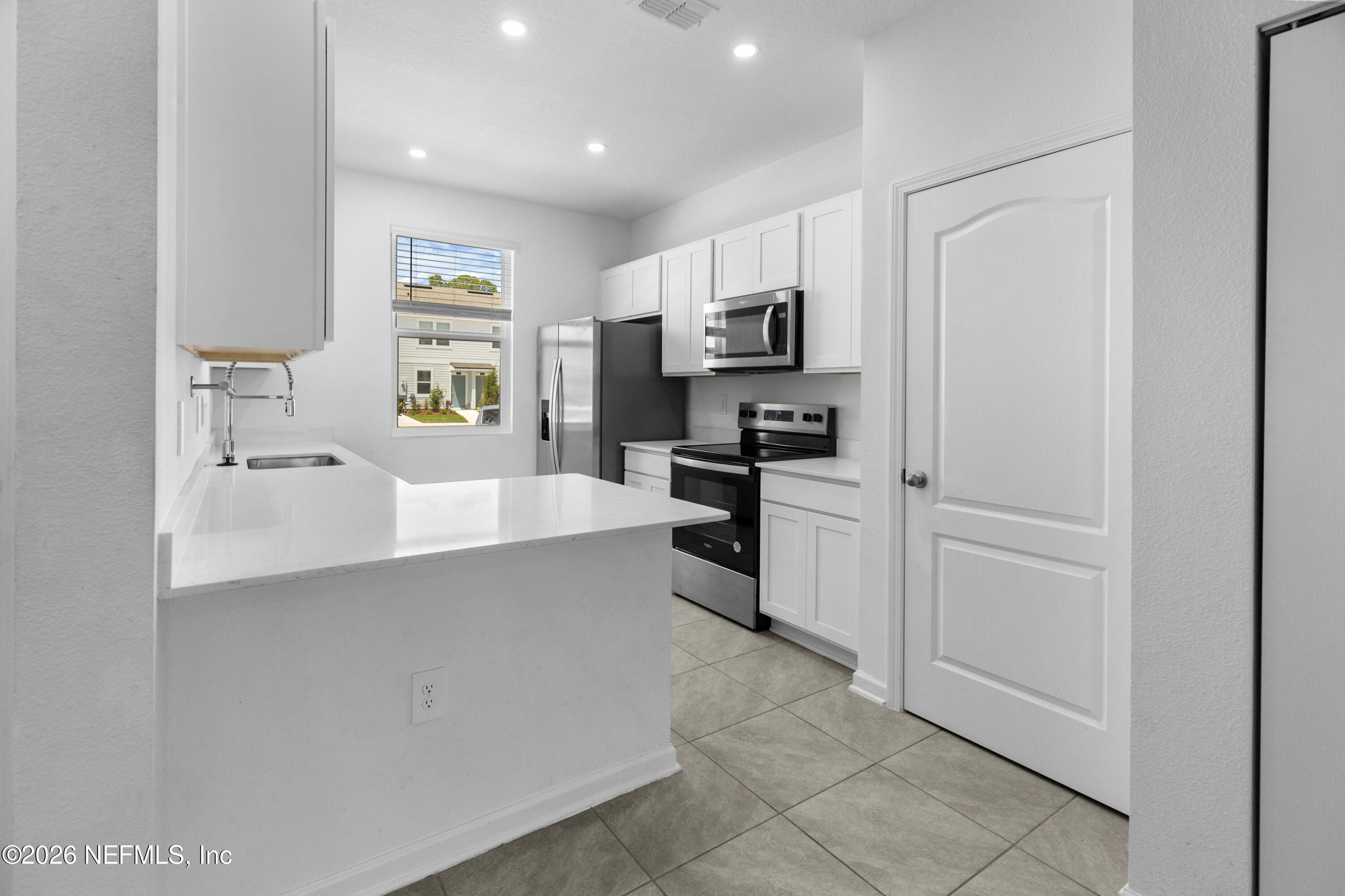 46 Wading Ibis Road St. Augustine, FL 32095 - Photo 7 of 31 a large white kitchen with cabinets and stainless steel appliances