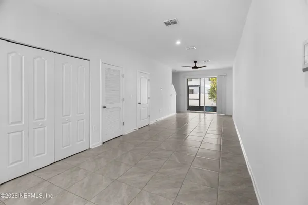 a view of a hallway with wooden floor and a window