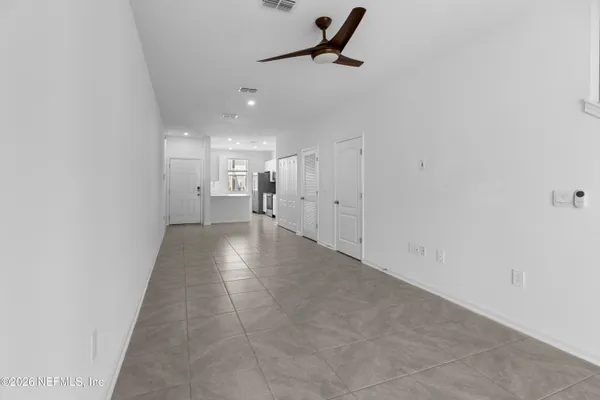 a view of a hallway with a refrigerator