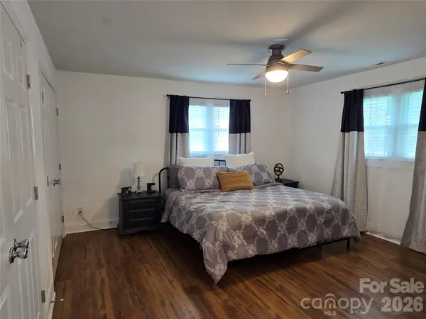 a bedroom with a bed and a mirror