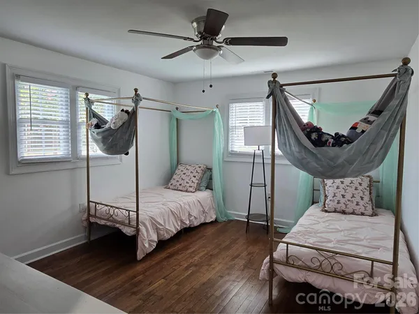 a bedroom with a bed a window and a chandelier