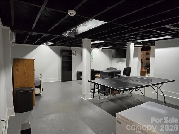 a dining room with furniture and a flat screen tv