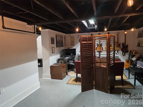 a water heater room with wooden floor