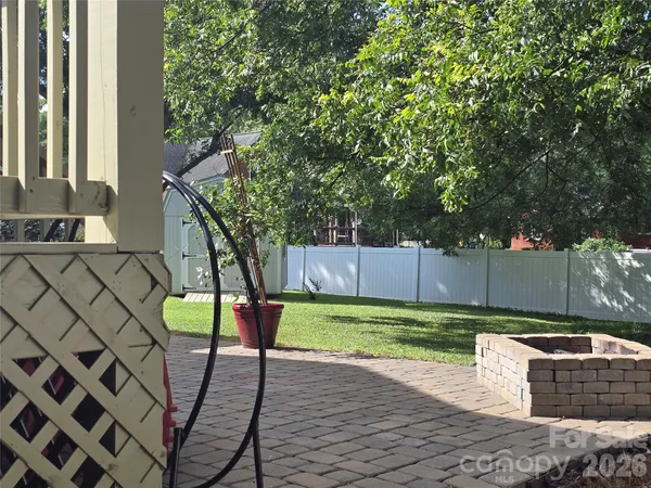 a view of a backyard with wooden fence