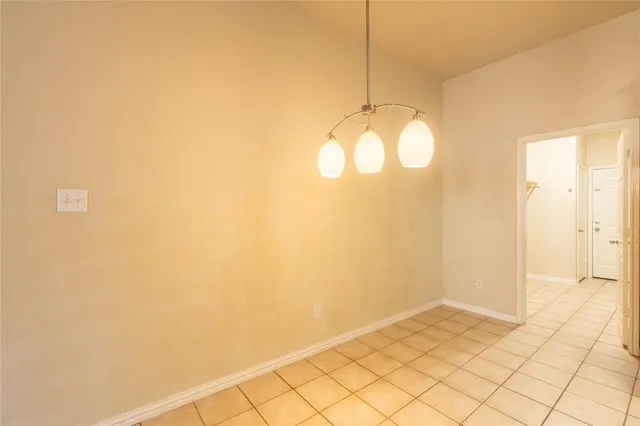 a view of a small space with wooden floor and a large window