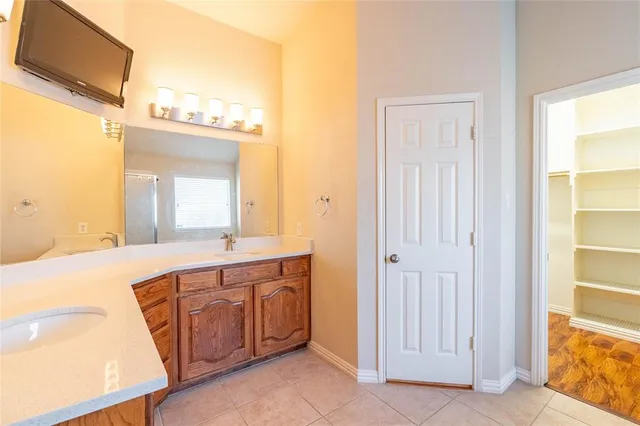 a large bathroom with a sink a mirror and a bathtub