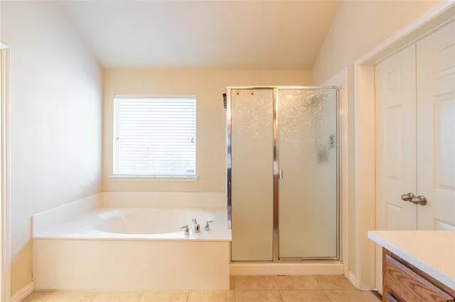 a bathroom with a bathtub and a shower