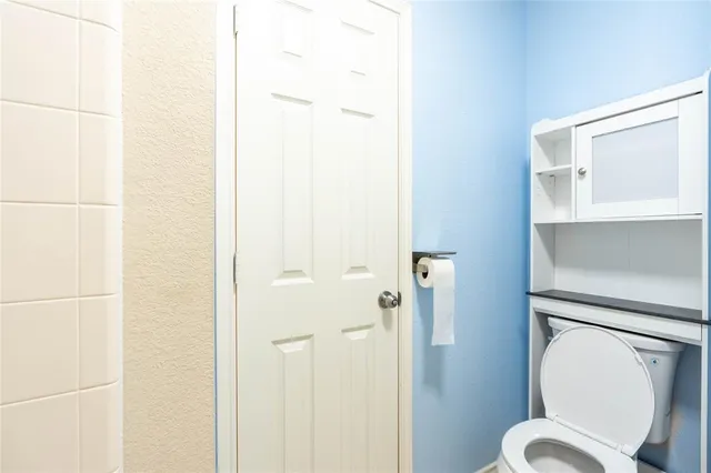 a white toilet sitting next to a bathroom sink