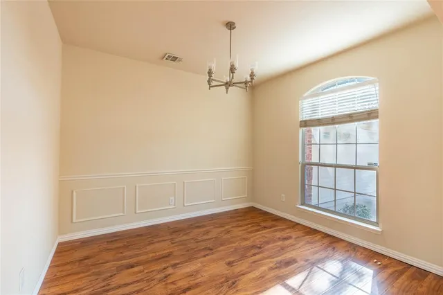 a view of a room with wooden floor and windows
