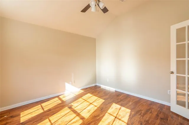 a view of a room with wooden floor and carpet