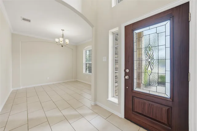 an empty room with a ceiling fan and a window