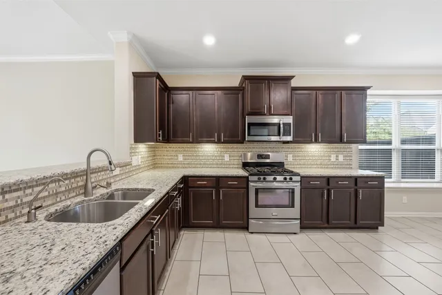 a view of a big house with a big yard and large trees