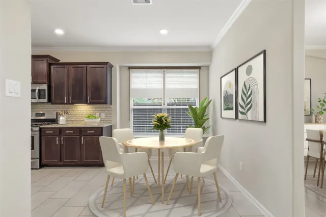 a bedroom with two separate beds and a potted plant