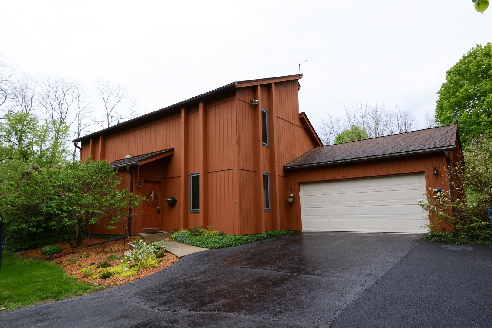 a front view of house along trees