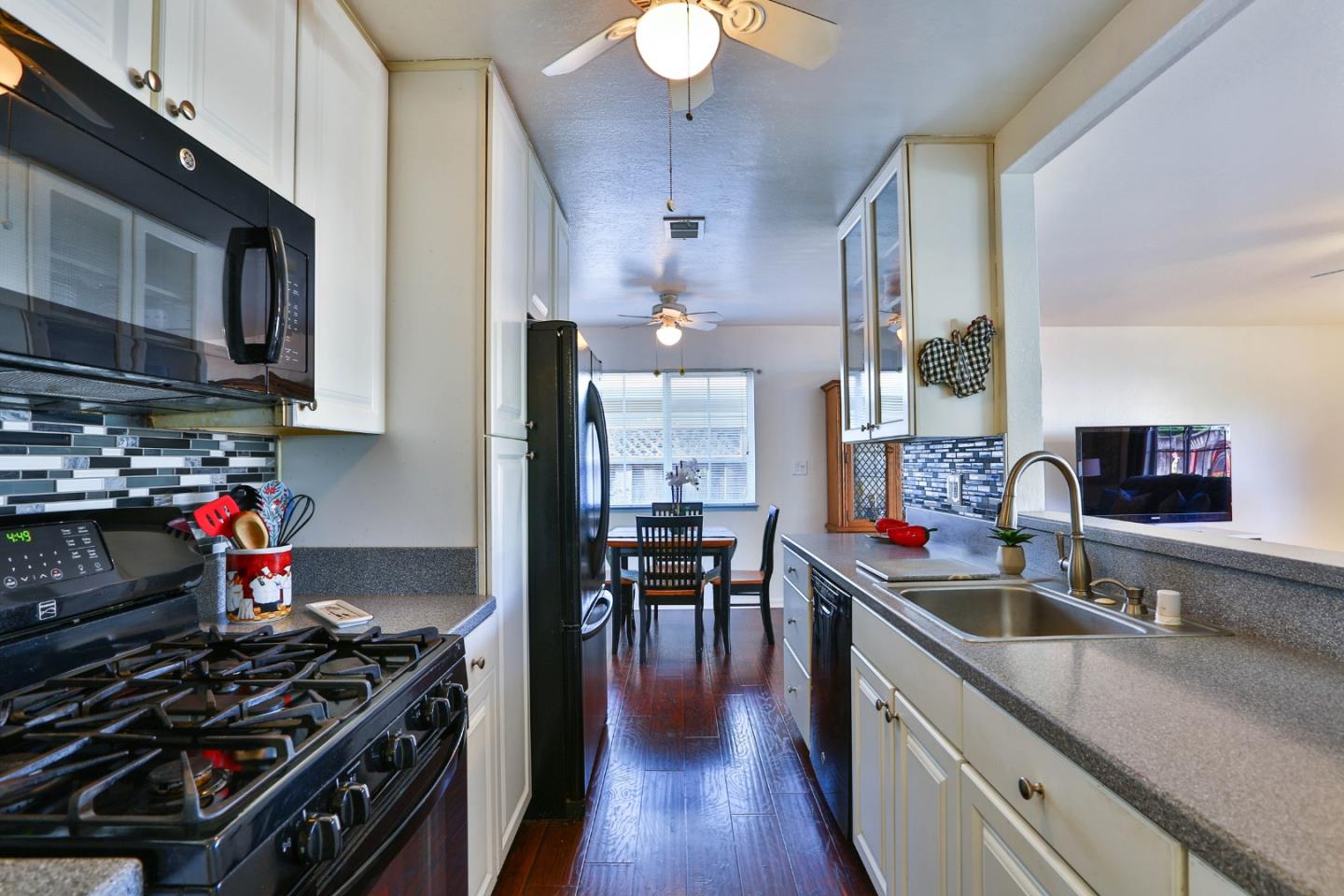 1735 Cunningham Street Santa Clara, CA 95050 - Photo 14 of 38 a kitchen with lots of counter top space and wooden floor