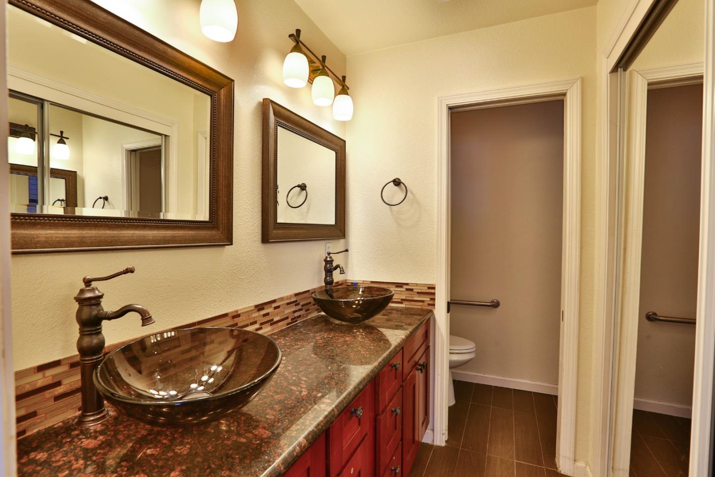 1735 Cunningham Street Santa Clara, CA 95050 - Photo 23 of 38 a bathroom with a granite countertop sink and a mirror