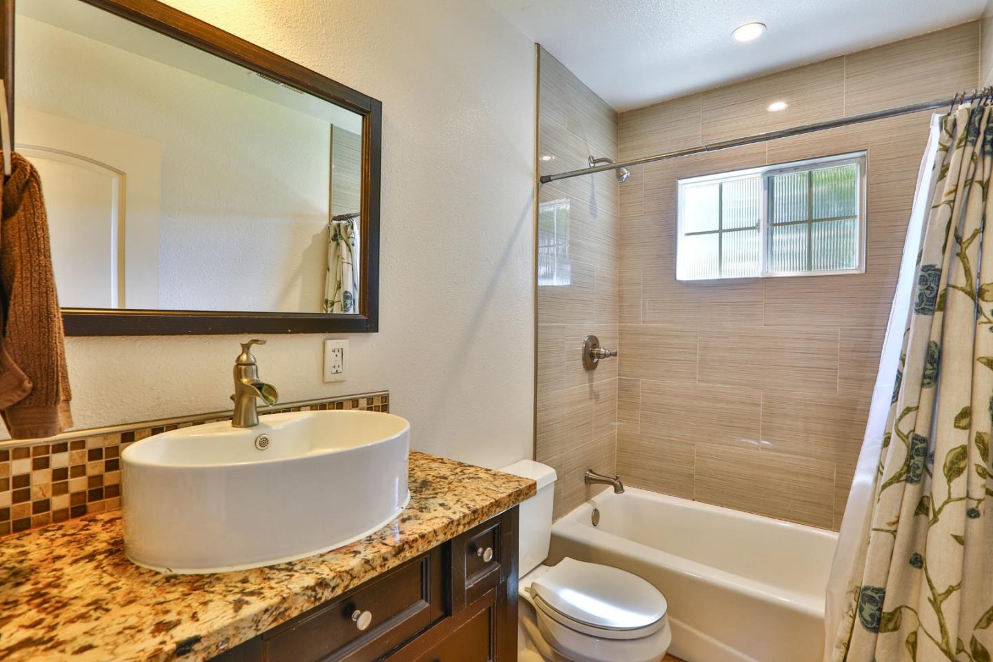 1735 Cunningham Street Santa Clara, CA 95050 - Photo 28 of 38 a bathroom with a granite countertop sink toilet a mirror and bathtub