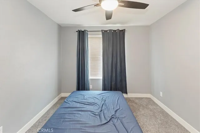 a bedroom with bed and a window