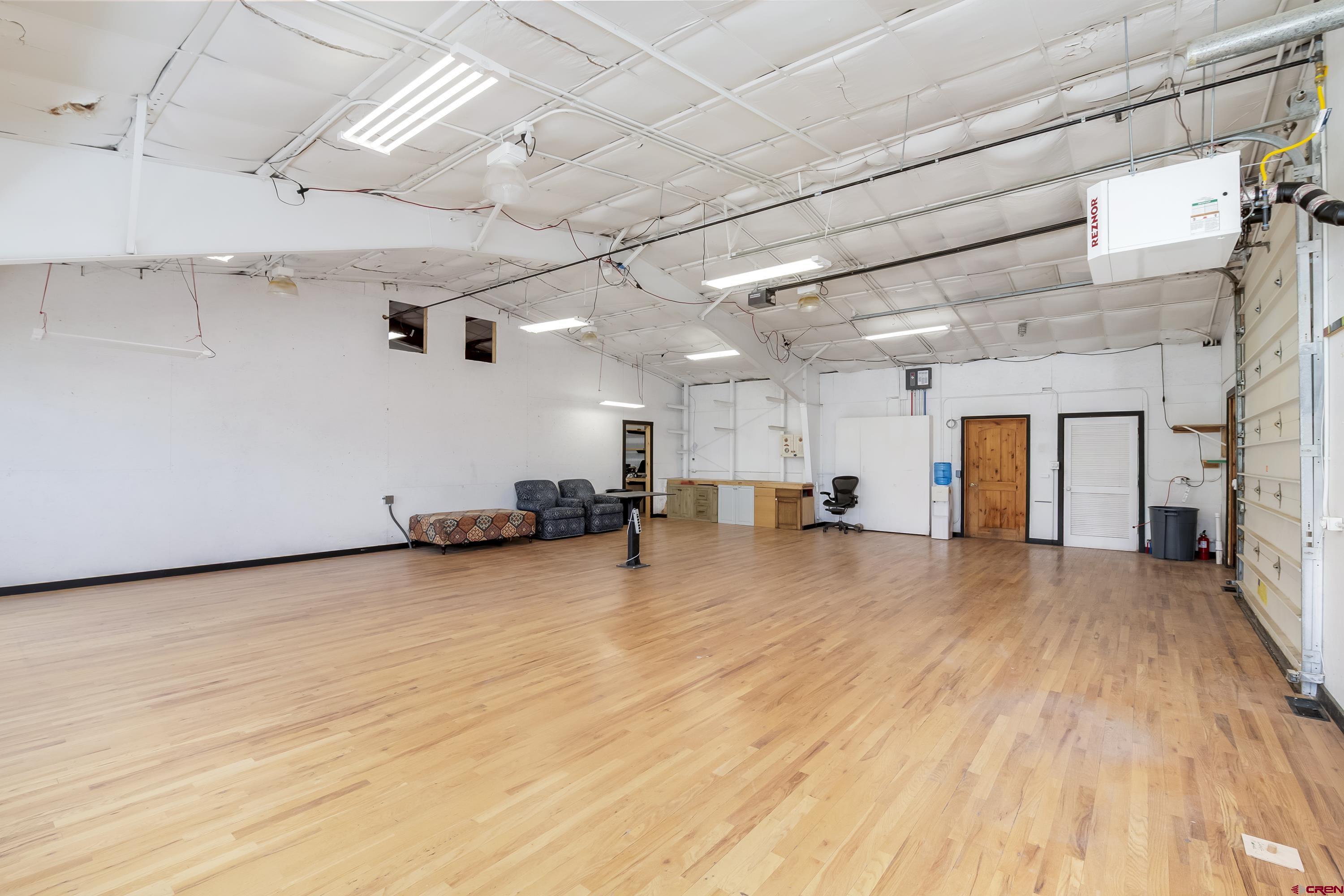 110 Andreas Circle, Unit A Crested Butte, CO 81224 - Photo 8 of 21 a big room with wooden floor and windows