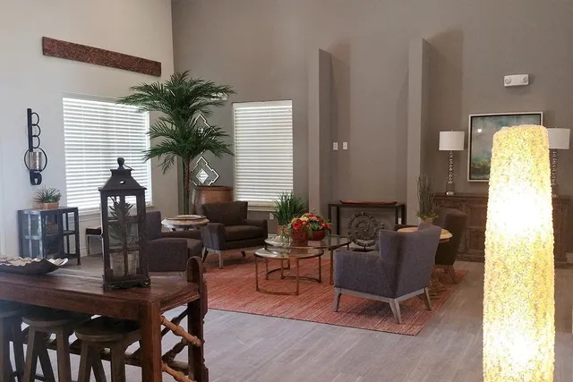 a living room with furniture and a potted plant