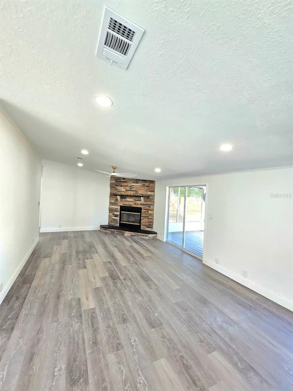 4928 Rollinglen Loop East Lakeland, FL 33810 - Photo 12 of 44 a view of empty room with wooden floor and fan
