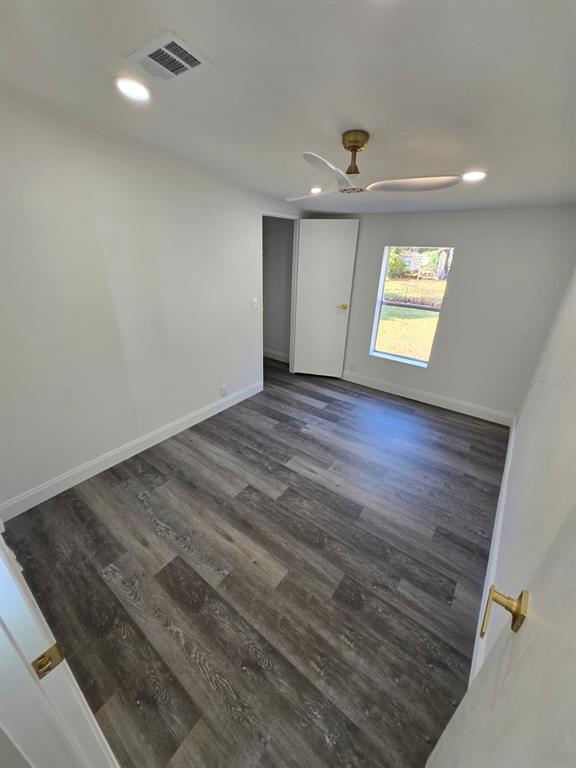 4928 Rollinglen Loop East Lakeland, FL 33810 - Photo 19 of 44 wooden floor in an empty room with a window