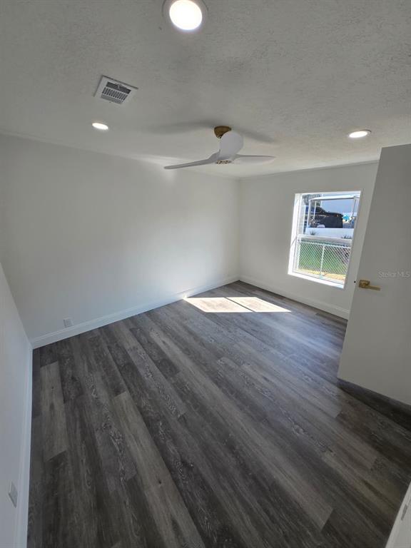 4928 Rollinglen Loop East Lakeland, FL 33810 - Photo 22 of 44 a view of an empty room with wooden floor and a window